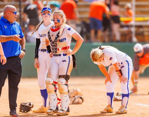 Branford coach Oscar Saavedra and players Madyson Sikes (from left), Morgan Brennan and Laila Arnold show their emotion after losing to Trenton in the Class 1A state championship on Saturday. (JACK HOWDESHELL/Special to the Reporter)