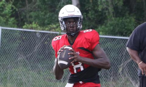 Fort White quarterback Jayden Jackson rolls out to pass during practice on May 1. (MORGAN MCMULLEN/Lake City Reporter)
