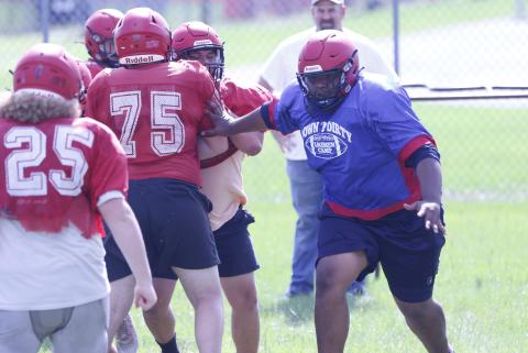 Lafayette offensive lineman Troy Mares performs a run-blocking drill during Monday’s practice. (JAMIE WACHTER/Lake City Reporter)