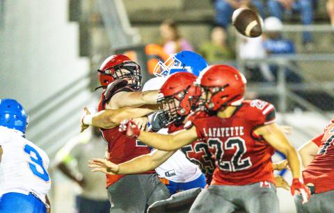 Lafayette quarterback Tucker Higginbothom gets hit by a Taylor County defender after throwing a pass during the teams’ spring game on May 23. (JACK HOWDESHELL/Special to the Reporter)