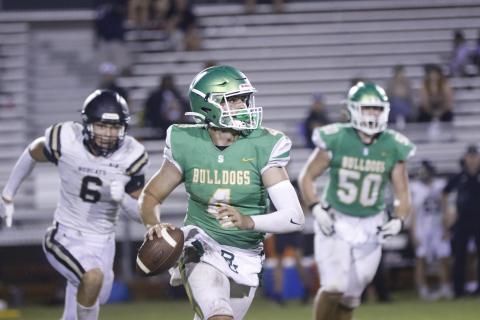 Suwannee quarterback Thomas Sikes looks for a receiver as he rolls out against Buchholz during Thursday's spring jamboree at Langford Stadium. (JAMIE WACHTER/Lake City Reporter)