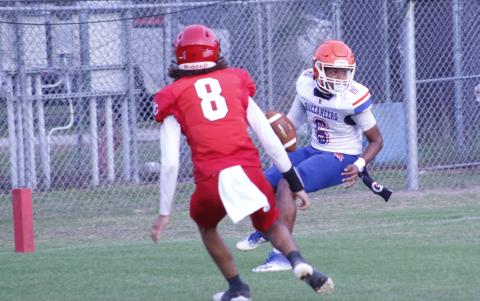Branford quarterback Damian Herrera is pressured in the end zone by Dixie County’s Curtis Copeland. The play resulted in a safety. (JAMIE WACHTER/Lake City Reporter)