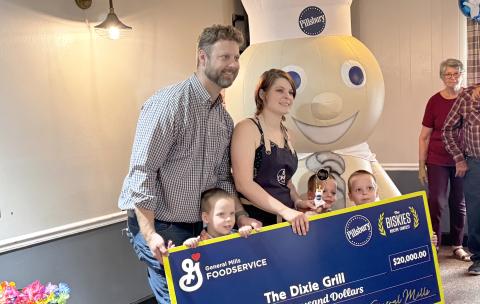 Rebecca and Robbie Thomas, chefs at the Dixie Grill, are joined by their sons, Colby, Carter and Conner, with the $20,000 prize check from winning The Biskies Contest. (JAMIE WACHTER/Lake City Reporter)