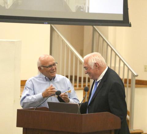 Columbia County School Board member Keith Hudson receives the key to the City of Lake City from Mayor Stephen Witt during Tuesday’s board meeting. The school board renamed the district auditorium in Hudson’s honor. Hudson has served on the board for 48 years and is running unopposed. (MORGAN MCMULLEN/Lake City Reporter)