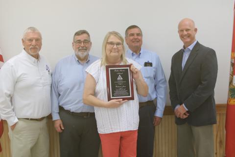 Greg Harden (from left), David Kraus, Steven Dicks and Jeb Smith stand with Lynn Jones after she received the Outstanding Public Official of the Year plaque in honor of her late husband, Richard Jones. (TONY BRITT/Lake City Reporter)
