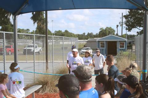 Mike Null, the president of the Lake City Columbia County Tennis Association, talks about the tennis courts at Youngs Park and the shade structure that was dedicated Thursday morning. (TONY BRITT/Lake City Reporter)