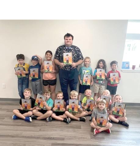 Austin Phelps met with the Lafayette 4-H Cloverbuds during 4-H Fundamentals camp. Phelps showed off skills with a basketball and balloon animals while the Cloverbuds received autographed copies of the the book, ‘The Original Mr. Phelps.’ (COURTESY)