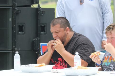 Steven Flores takes part in the hot dog eating contest during the Rotary Club of Lake City’s Independence Day celebration last year at Wilson Park. The hot dog eating contest will be back as part of this year’s event. (FILE)