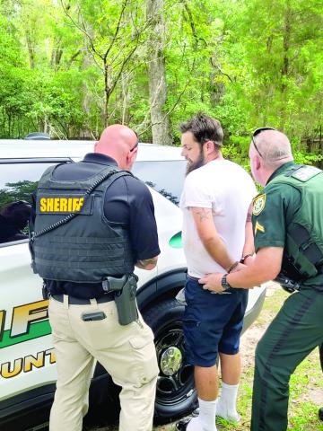 Matthew Gooch is taken into custody by the Columbia County Sheriff’s Office after being accused of firing 10-plus shots into a residence Wednesday morning. (COURTESY CCSO)