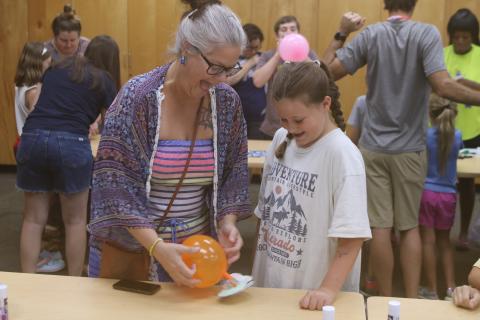 Laura Hicks (from left) and her daughter, Ava Wilson, enjoy testing out their hovercraft experiment at the Columbia County Public Library’s STEAM lab Friday. (TONY BRITT/Lake City Reporter)
