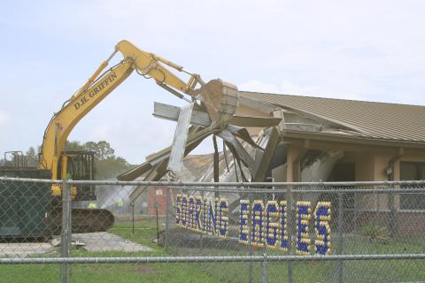 Crews began knocking down the office area at Niblack Elementary School on Wednesday as demolition is underway to create room for a new school on the site. (TONY BRITT/Lake City Reporter)