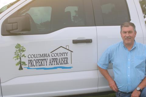 Columbia County Property Appraiser Jeff Hampton shows off the office’s new logo, which has been added to the sides of the employees’ trucks to make them easier to identify. (TONY BRITT/Lake City Reporter)