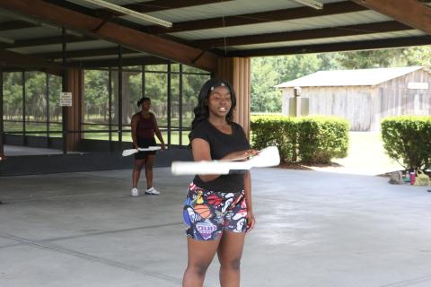 Eri’Yonna Jones, a CHS color guard captain, demonstrates a drop spin at Tuesday’s practice. (MORGAN MCMULLEN/Lake City Reporter)