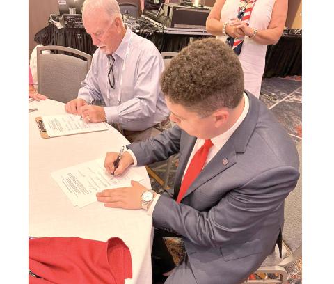 Hunter Peeler, the Columbia County Republican Party chairman, signs paperwork Monday at the Republican National Convention to nominate Donald Trump as the Republican presidential candidate. (COURTESY)