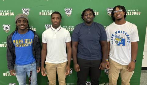 Suwannee’s Marquavious Owens (from left) signed his letter of intent Tuesday to compete in football and weightlifting, while PJ Davis signed with LaGrange College to play baseball, Justice Leggett signed for weightlifting at Warner University and Ja’Darius Cherry signed to play football at Allen University. (COURTESY)
