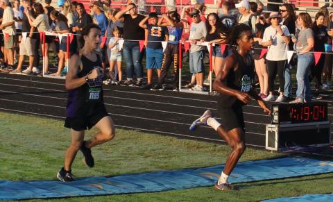 Columbia runner John Ringenberg (left) crosses the finish line to place 55th at the Middleburg Broncos Classic on Saturday. (COURTESY)