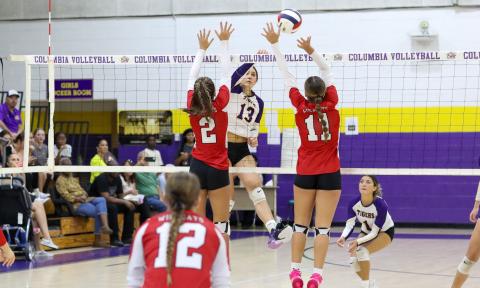 Columbia hitter Kayla Goodloe fires a shot at two Baker County defenders during Thursday's match. (BRENT KUYKENDALL/Lake City Reporter)