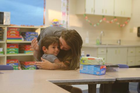 Gunner Statham, 5, a kindergarten student at Five Points Elementary School, flashes a tearful first day of school look as he’s hugged by Gracey Hudson on Monday. (TONY BRITT/Lake City Reporter)