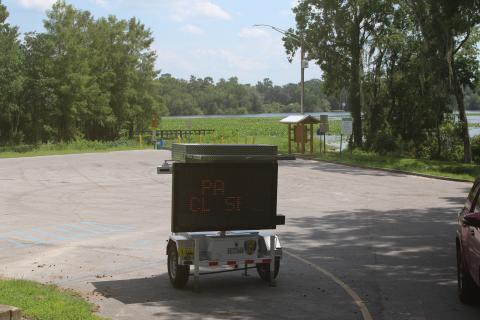 A digital sign sits in the parking lot at Campbell Park and Lake Mongtomery alerting residents that the park will be closed beginning Tuesday for construction of a new fishing pier on the lake. (TONY BRITT/Lake City Reporter)