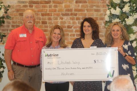Don Fenneman (from left), stands with Jennifer Anchors, Bebe Willis and Pam Hyde as he presents a  check for $91,740 to the United Way of Suwannee Valley during the agency’s breakfast meeting on Thursday. (TONY BRITT/Lake City Reporter)