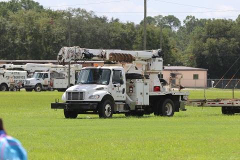 Power trucks staged Saturday at the Florida Gateway Fairgrounds in preparation for Tropical Storm Debby. The trucks, from various companies across the country, will help Florida Power & Light restore power where needed after impact. (JAMIE WACHTER/Lake City Reporter)