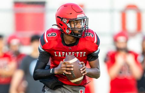 Lafayette quarterback Tywan Williamson rolls out to pass against Tyalor County during the teams’ spring game on May 23. (JACK HOWDESHELL/Special to the Reporter)