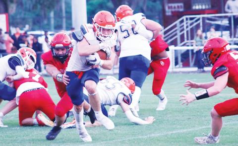 Branford running back Trevor Maddox breaks through a tackle against Dixie County during the teams’ spring game on May 17. (JAMIE WACHTER/Lake City Reporter)