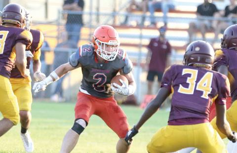Branford running back Trevor Maddox looks for room to run against Crescent City during a three-team preseason jamboree on Aug. 16. (MORGAN MCMULLEN/Lake City Reporter)