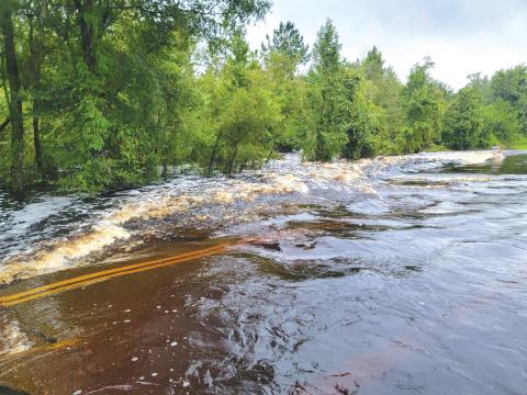Flood waters rush across Falling Creek Road on Monday after Hurricane Debby passed through. Columbia County Fire Rescue firefighters pulled a woman from a flood vehicle in the waters Monday evening. (COURTESY COLUMBIA COUNTY FIRE RESCUE)