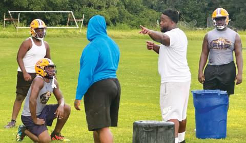 Former Columbia star Timmy Jernigan (right), who went on to play collegiately at Florida State and in the NFL, coaches up Columbia’s defensive line during Monday’s practice. (JORDAN KROEGER/Lake City Reporter)