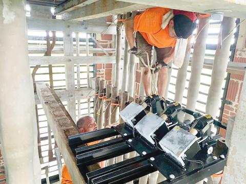 Workers install new bells in the carillon tower at Stephen Foster Folk Culture Center State Park. (COURTESY)