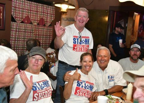 Suwannee County Sheriff Sam St. John (right) was all smiles Tuesday night after defeating challenger Jason Rountree in the primary election for sheriff. St. John was accompanied by Chief Deputy Buddy Williams and his wife, Tori St. John. (ROB WOLFE/Lake City Reporter)