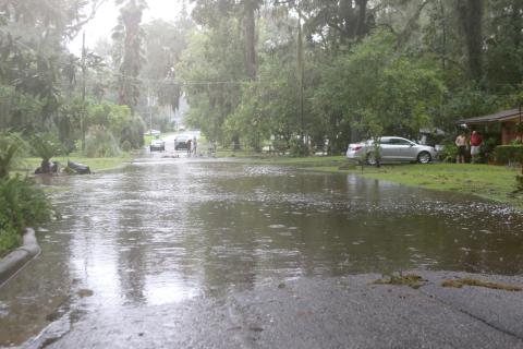 Flood waters cross over SE Inglewood Avenue in Lake City on Monday afternoon after Hurricane Debby dumped up to 16 inches of rain on the area. (TONY BRITT/Lake City Reporter)