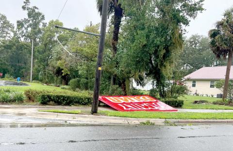 A Family Dollar sign was blown down onto the sidewalk along U.S. Highway 27 in Mayo during Hurricane Debby on Monday. (COURTESY)