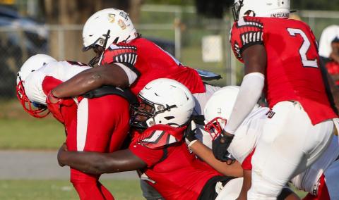 Fort White defensive linemen Chris Smith (top) and Jaden McCray (bottom) combine for a tackle against NFEI during the Preseason Classic on Aug. 15. (BRENT KUYKENDALL/Lake City Reporter)
