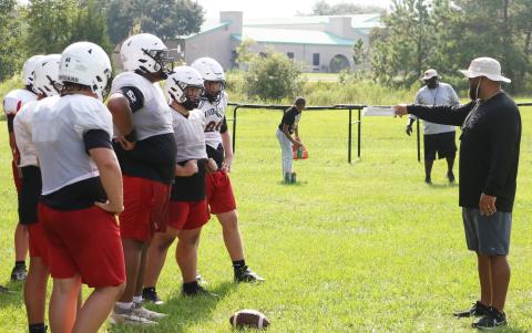 Fort White offensive line coach Jonathan Dupree gives instructions to his offensive line during Monday’s practice. (MORGAN MCMULLEN/Lake City Reporter)