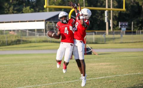 Fort White running back Keimarion Neal celebrates with quarterback Jayden Jackson after scoring a touchdown against NFEI during their Preseason Classic on Aug 15. (BRENT KUYKENDALL/Lake City Reporter)