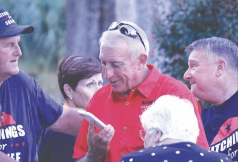 Wallace Kitchings (center) speaks on the phone after learning he’d won the race to be the next Columbia County Sheriff on Tuesday. Now, Kitchings says he’s invested in building relationships with the community. (JAMIE WACHTER/Lake City Reporter)