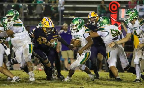 Suwannee running back Lou Jack Smith looks for running room as Columbia defensive lineman Caden Bolstein rushes in for a tackle last Friday. (BRENT KUYKENDALL/Lake City Reporter)