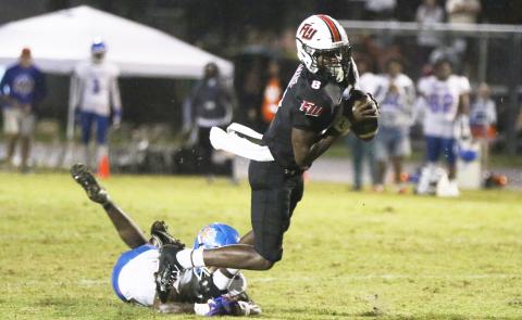 Fort White quarterback Jayden Jackson tries to escape the grasp of a Taylor County defender on Friday. (MORGAN MCMULLEN/Lake City Reporter)