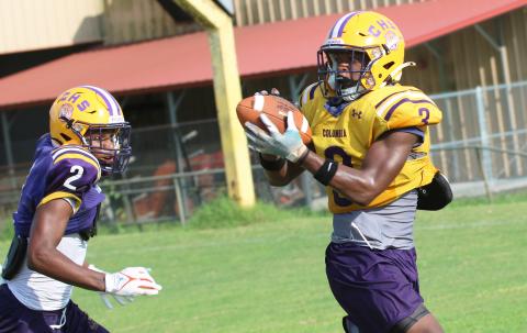 Columbia receiver Zamarion Jones (3) catches a pass ahead of defensive back Vondarius Lane (2) during Wednesday’s practice. (JORDAN KROEGER/Lake City Reporter)