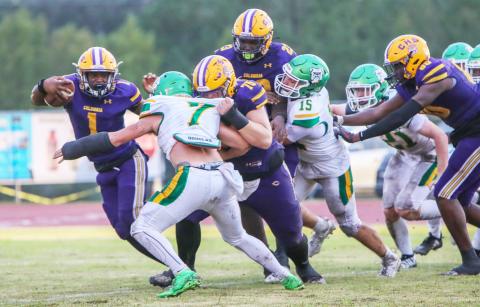 Columbia quarterback Zamarion Jones scrambles up field as center Zackery Grimes blocks Suwannee linebacker Jace Moran during Friday’s game. (BRENT KUYKENDALL/Lake City Reporter)