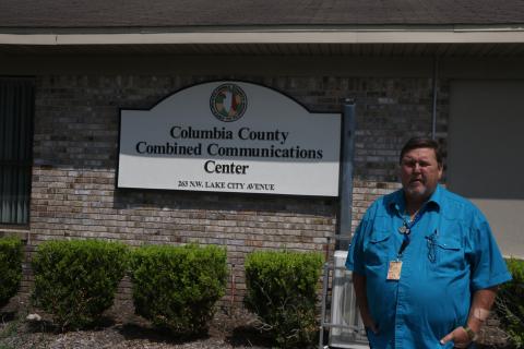 Tom Brazil, Columbia County’s 911 director, stands outside the Combined Communications Center on Tuesday. The county and City of Lake City consolidated their emergency dispatch last week. There have been no major issues so far, Brazil said. (MORGAN MCMULLEN/Lake City Reporter)