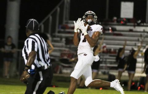 Fort White receiver Tafari Moe catches a long scoring pass against Belleview on Friday night. (MORGAN MCMULLEN/Lake City Reporter)