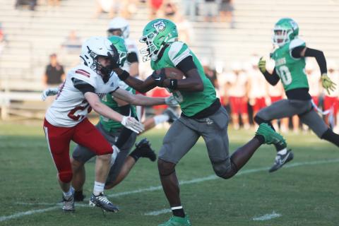 Suwannee receiver MJ Rossin stiff arms Bishop Kenny’s Brady Wagner as he returns the opening kickoff for a touchdown during Friday’s Preseason Classic. (PAUL BUCHANAN/Special to the Reporter)