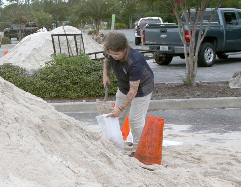 Amber Clark fills up a sandbag at Southside Sports Complex as she prepares for Tropical Storm Debby. (TONY BRITT/Lake City Reporter).