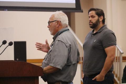 Columbia County Code Enforcement Officer Winston Warner talks to the County Commission about issues with complaints in the Town of Fort White on Thursday while Alexander Veiga, co-owner of The Collective: Food Yard and Garden, looks on. The commission voted to terminate its agreement to handle code enforcement for the town. (JAMIE WACHTER/Lake City Reporter)