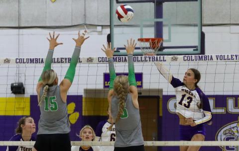 Columbia hitter Kayla Goodloe fires a shot as Suwannee's Maci Hingson (15) and Brooke Fernald (5) defend on Sept. 3. (BRENT KUYKENDALL/Lake City Reporter)