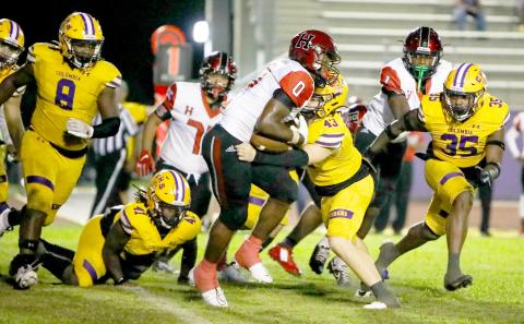 Columbia linebacker Bryson Grinstead wraps up Hillsborough running back Tariq Johnson last Friday night. (BRENT KUYKENDALL/Lake City Reporter)