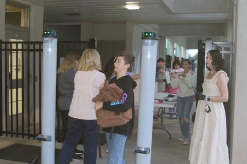 A Fort White student anxiously looks at the detection lights on one of the school’s new metal detectors while passing through. Fort White High added four metal detectors Monday morning to increase school security after threats last week. (TONY BRITT/Lake City Reporter)